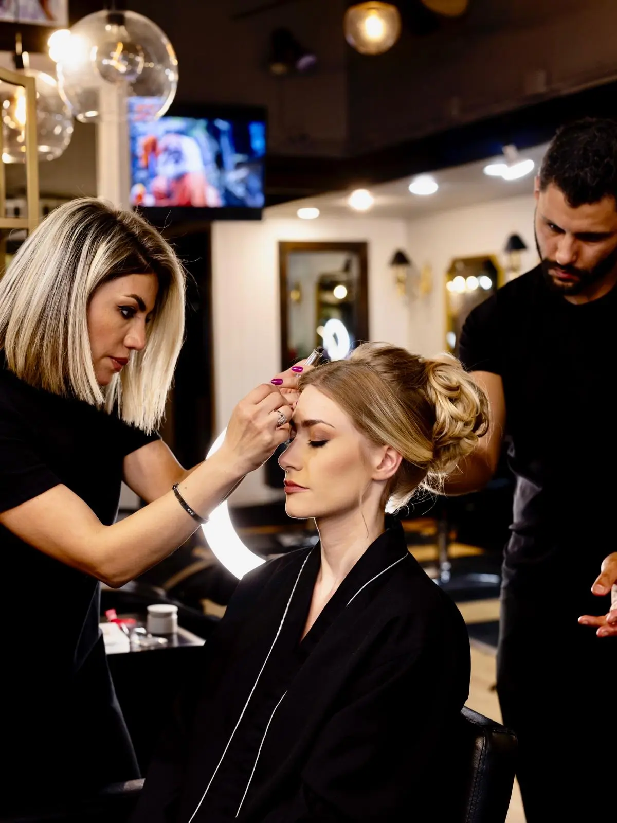 Woman receiving a haircut at Essential Hair Salon in Kirkland